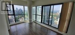 A large room with a view of the city through the windows.