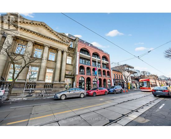 A street view with cars, a bus, and a tram.