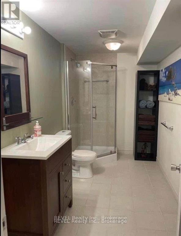 A bathroom with a toilet, sink, and shower.