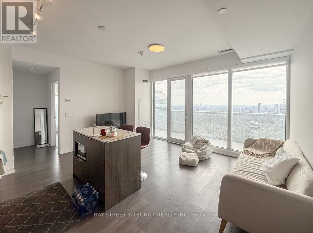 A living room with a couch, a coffee table, and a television.