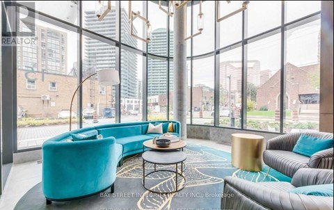 A living room with a blue couch and a coffee table.