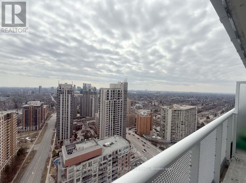 A cityscape with a cloudy sky and buildings of various heights.