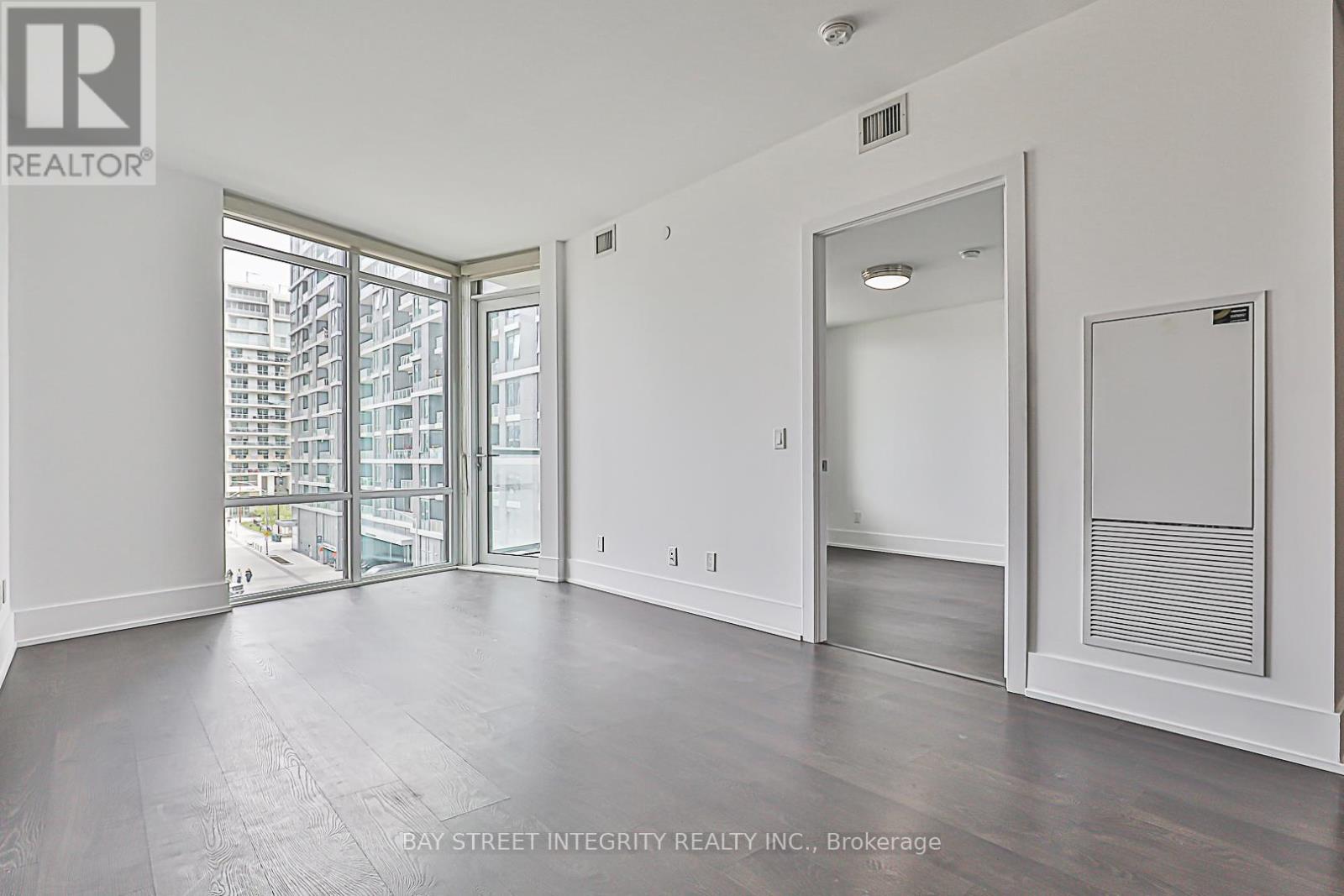 A spacious room with a view of the city through the windows.