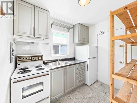 A kitchen with white appliances and wooden cabinets.