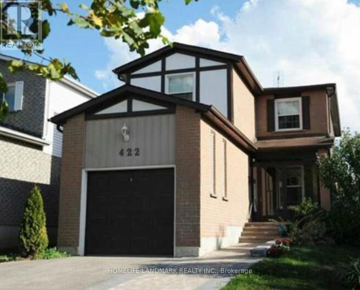 A modern house with a black garage door and a number 422 on the front.