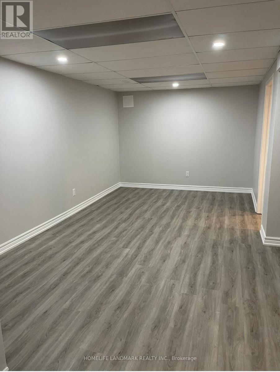 A room with wooden flooring and white walls.