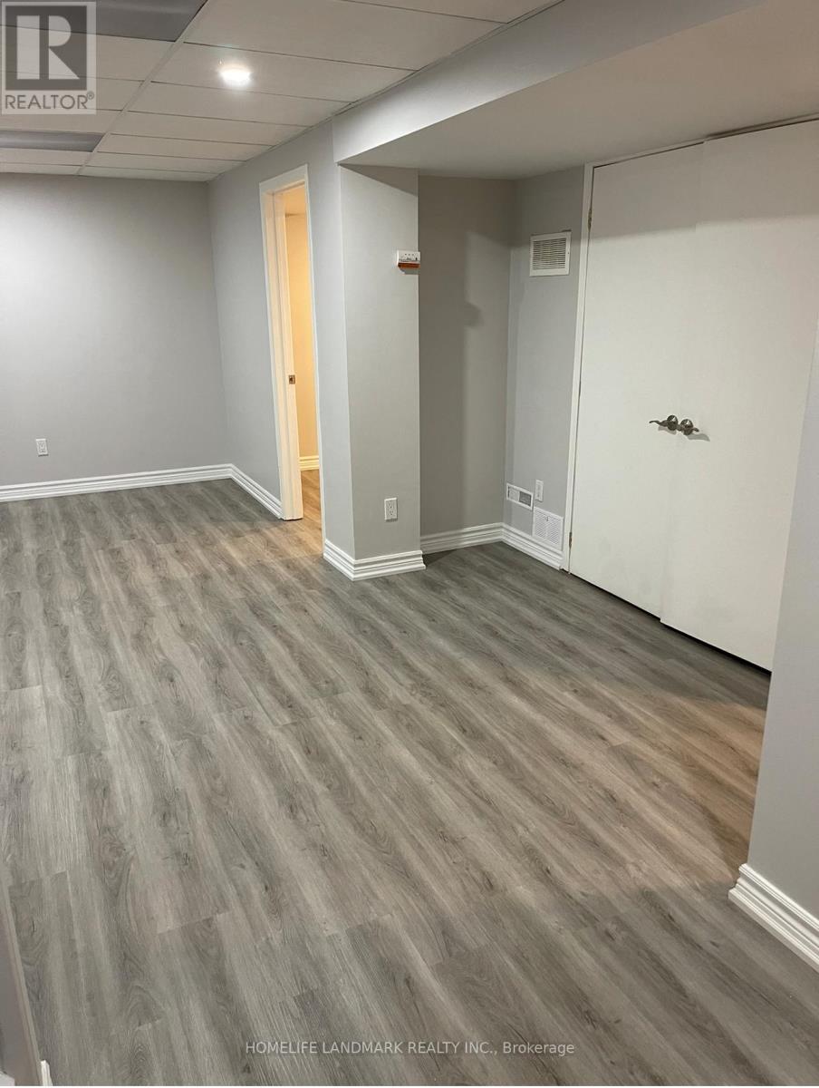 A room with grey walls and a wooden floor.