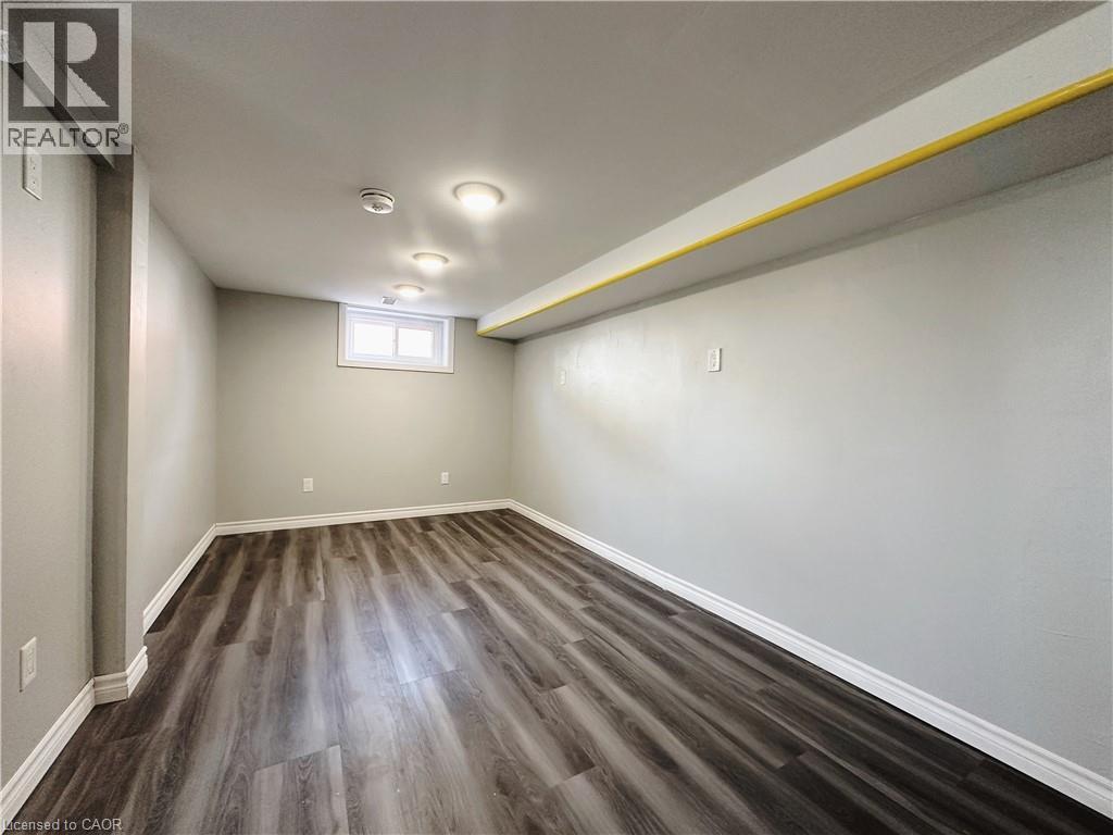 A room with wooden flooring and a window.