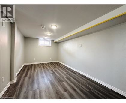 A room with wooden flooring and a window.