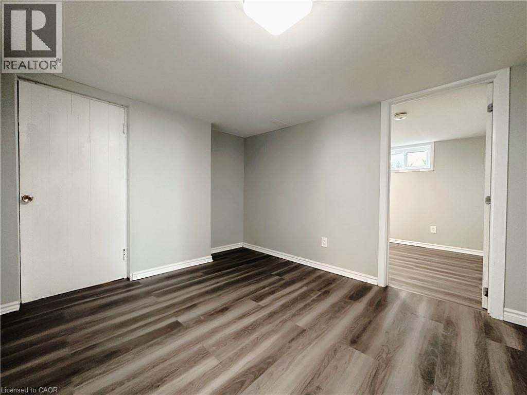 A room with wood flooring and white walls.