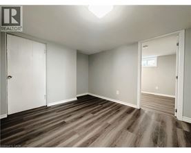 A room with wood flooring and white walls.