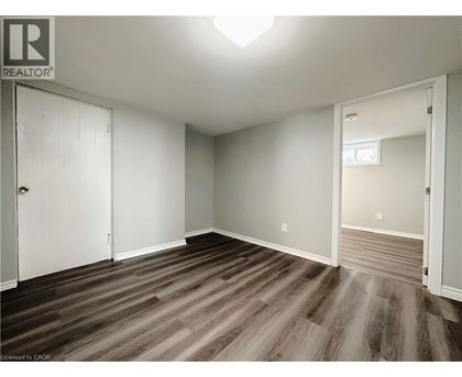 A room with wood flooring and white walls.