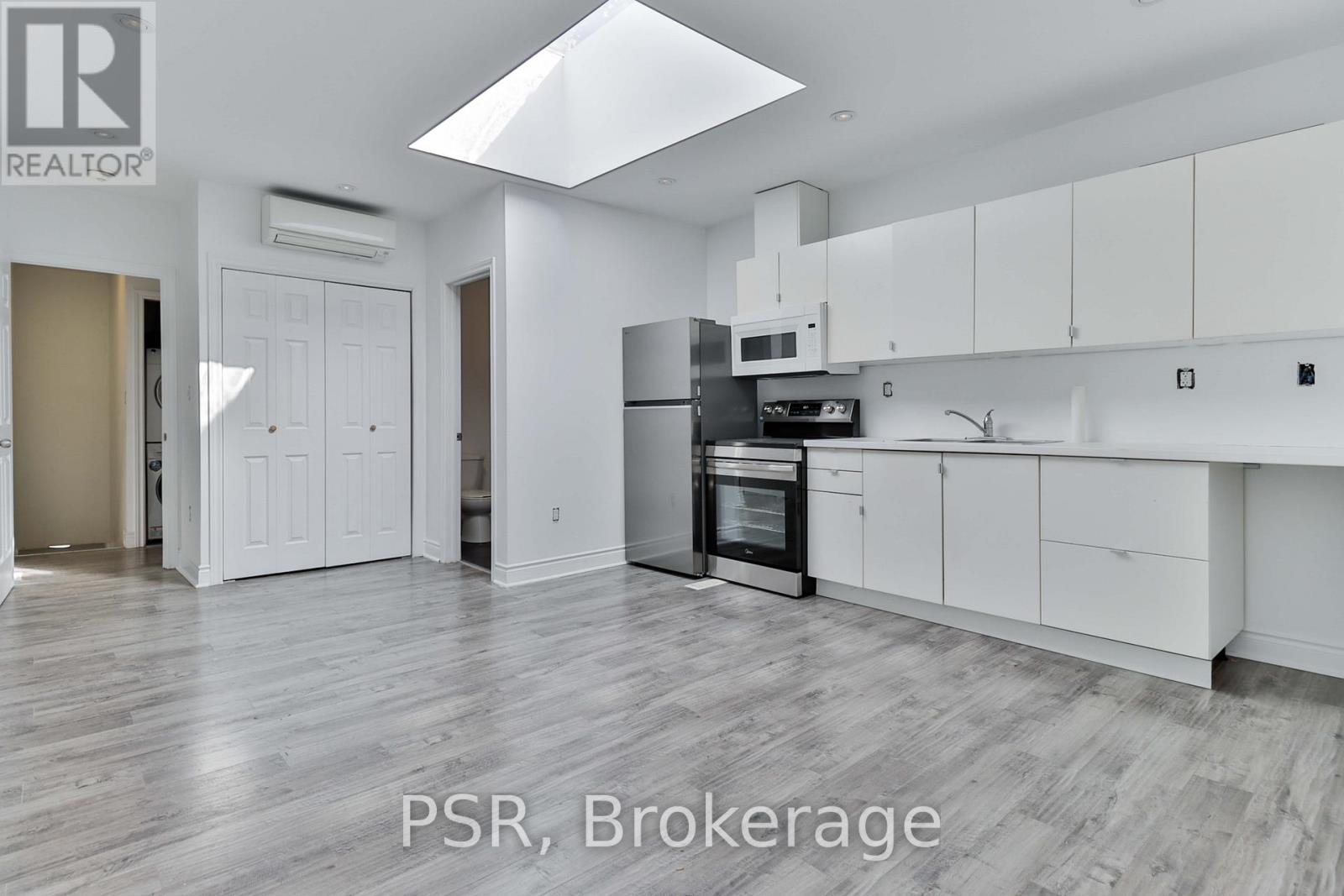A modern kitchen with white cabinets and a central island.