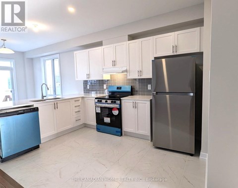 A kitchen with a blue dishwasher and a stove top oven.