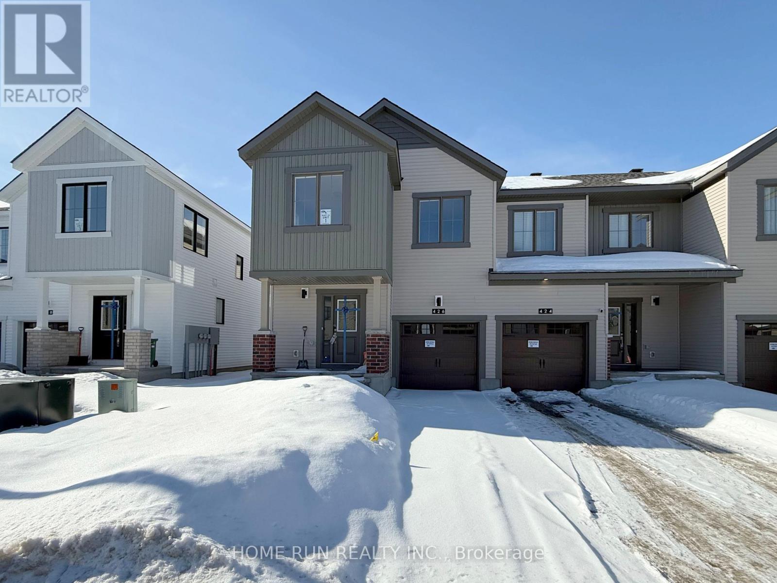 A row of houses with garages in front of them.