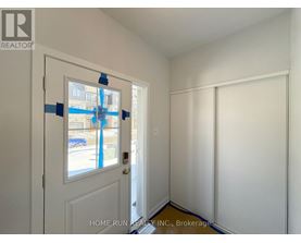 A room with a door and a wall with tape on it.