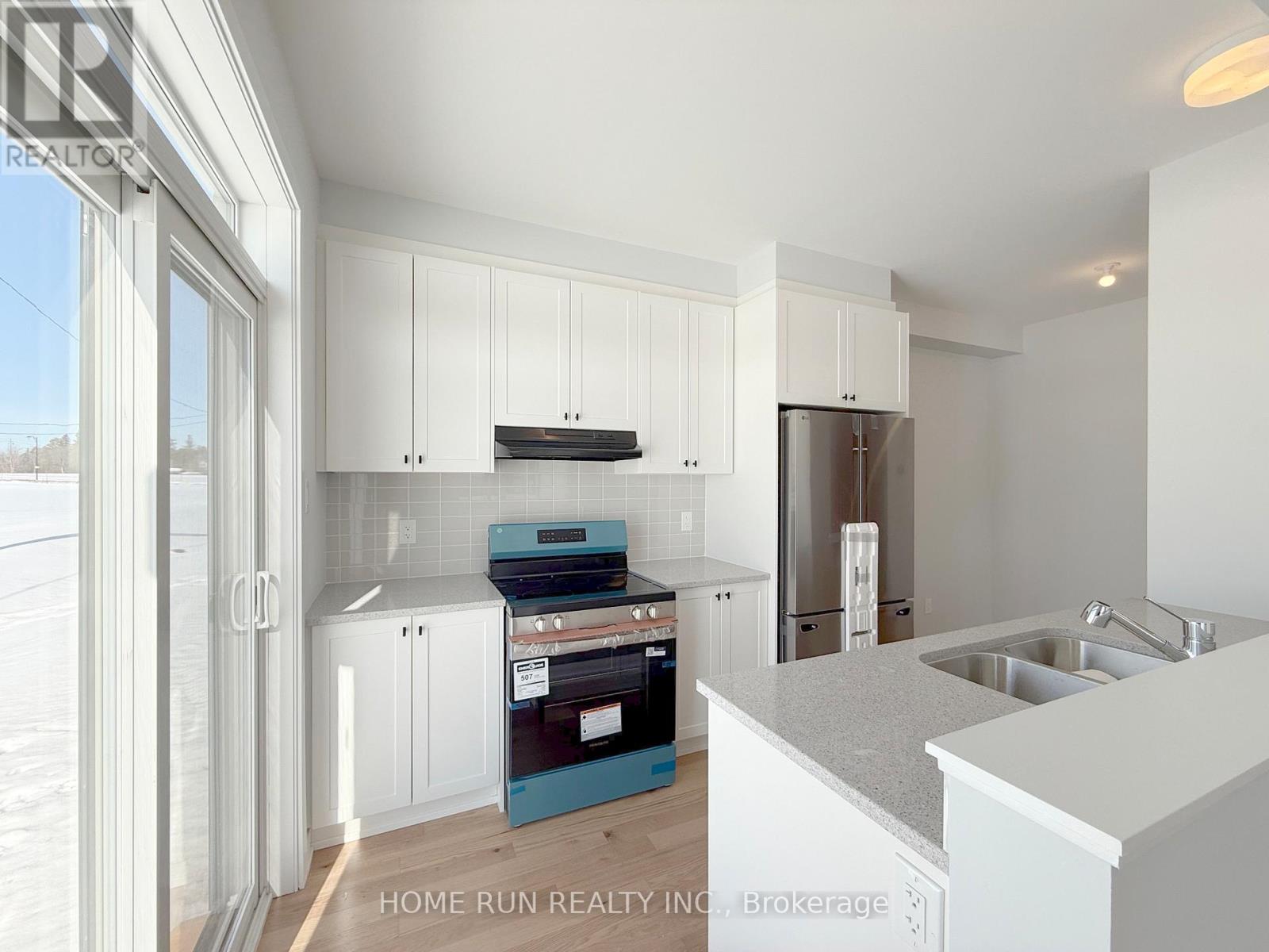 A kitchen with white cabinets and a blue drawer.