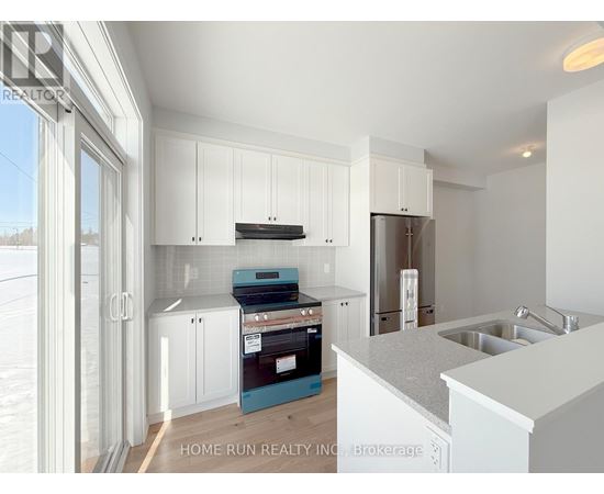 A kitchen with white cabinets and a blue drawer.