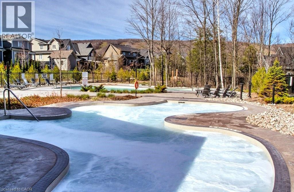 A large outdoor swimming pool with a slide.