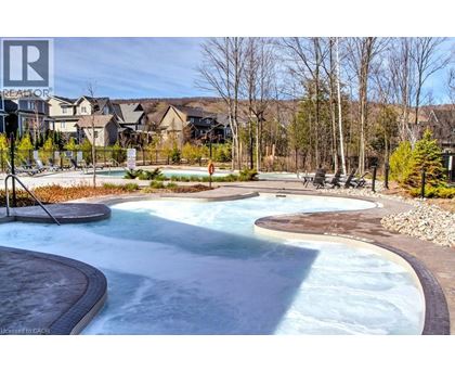 A large outdoor swimming pool with a slide.