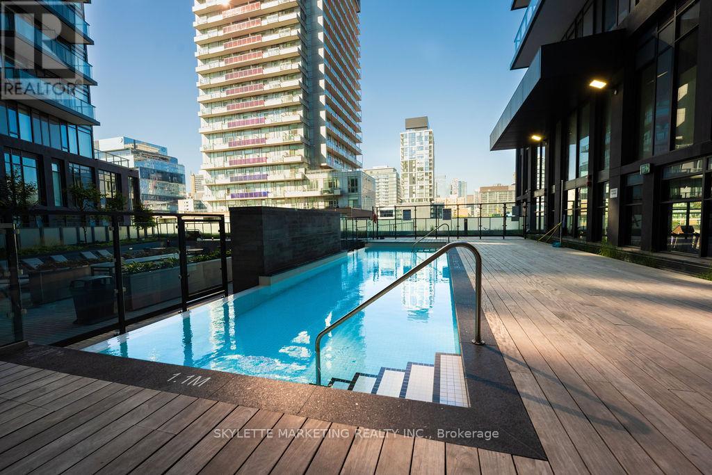 A pool on a balcony with a view of the city.