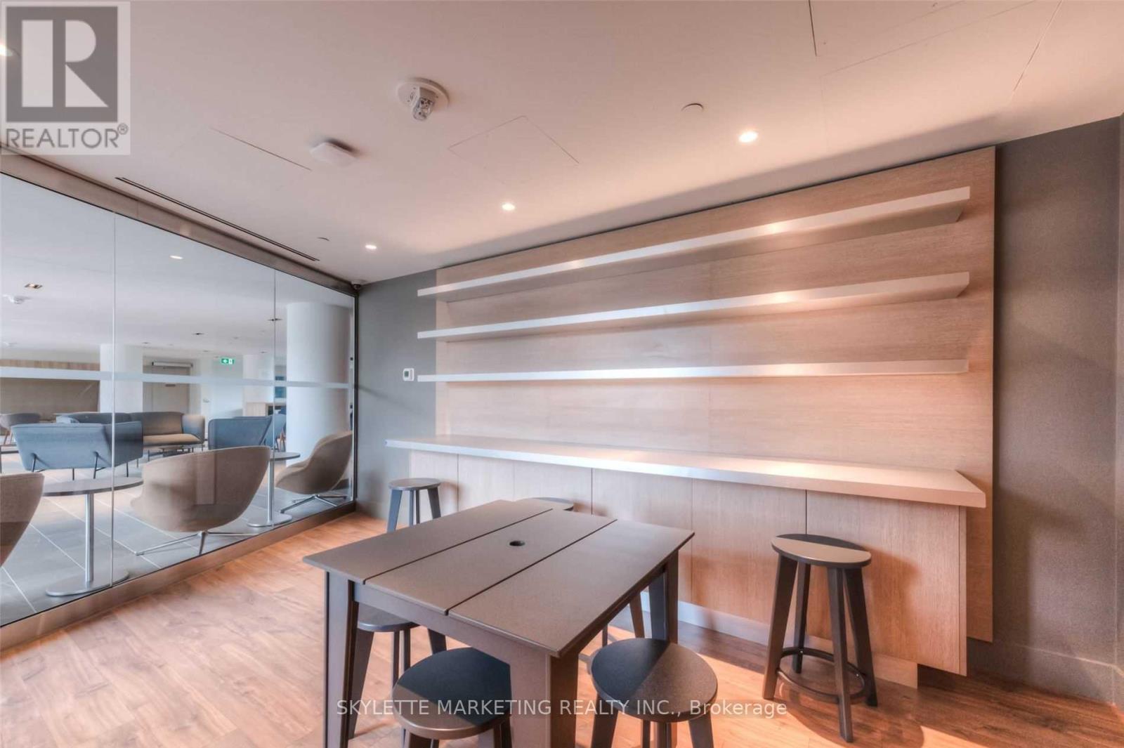 A modern dining room with a wooden table and chairs.