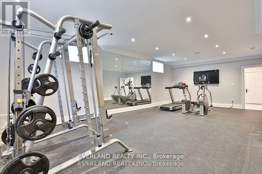 A well-equipped home gym with a variety of exercise machines.