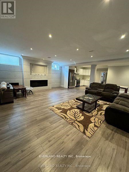 A living room with a rug and a fireplace.