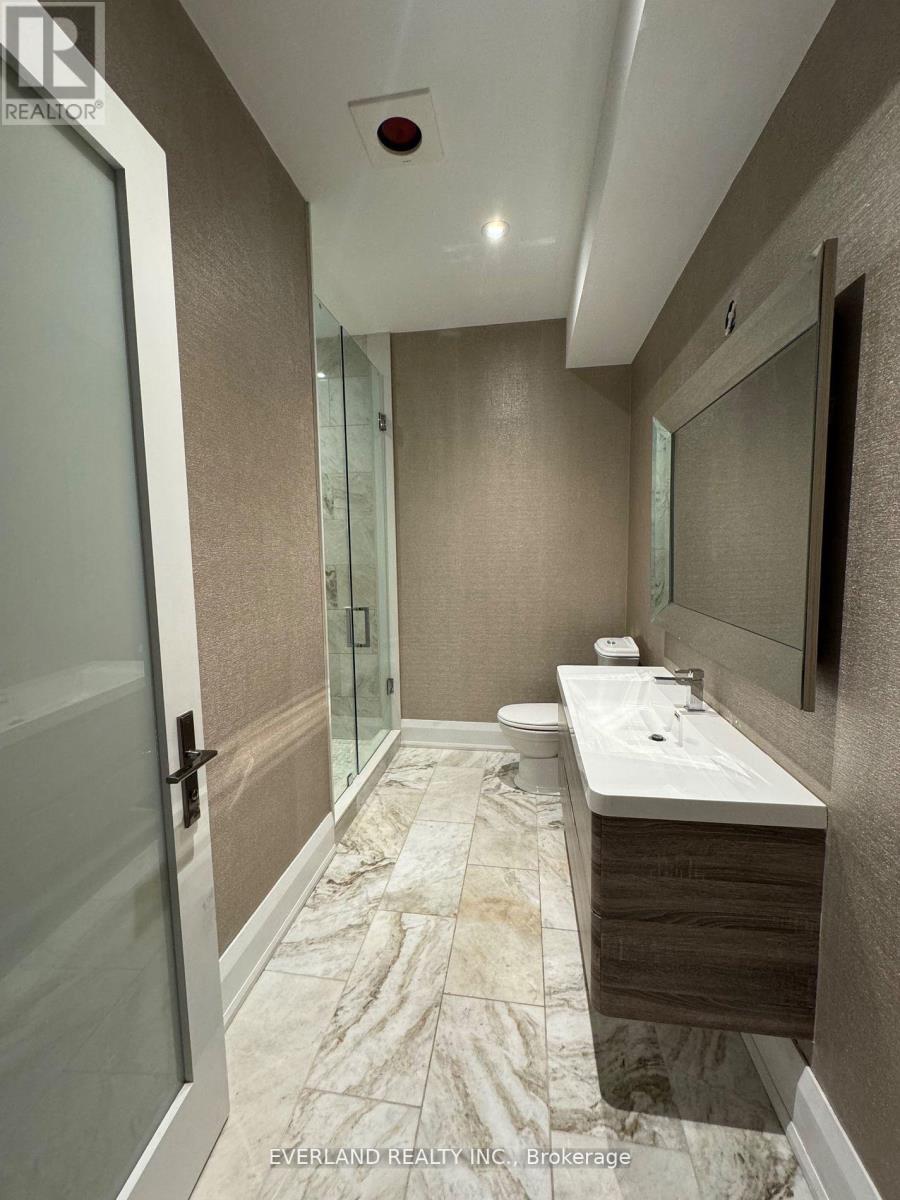 A bathroom with a marble floor and a white sink.