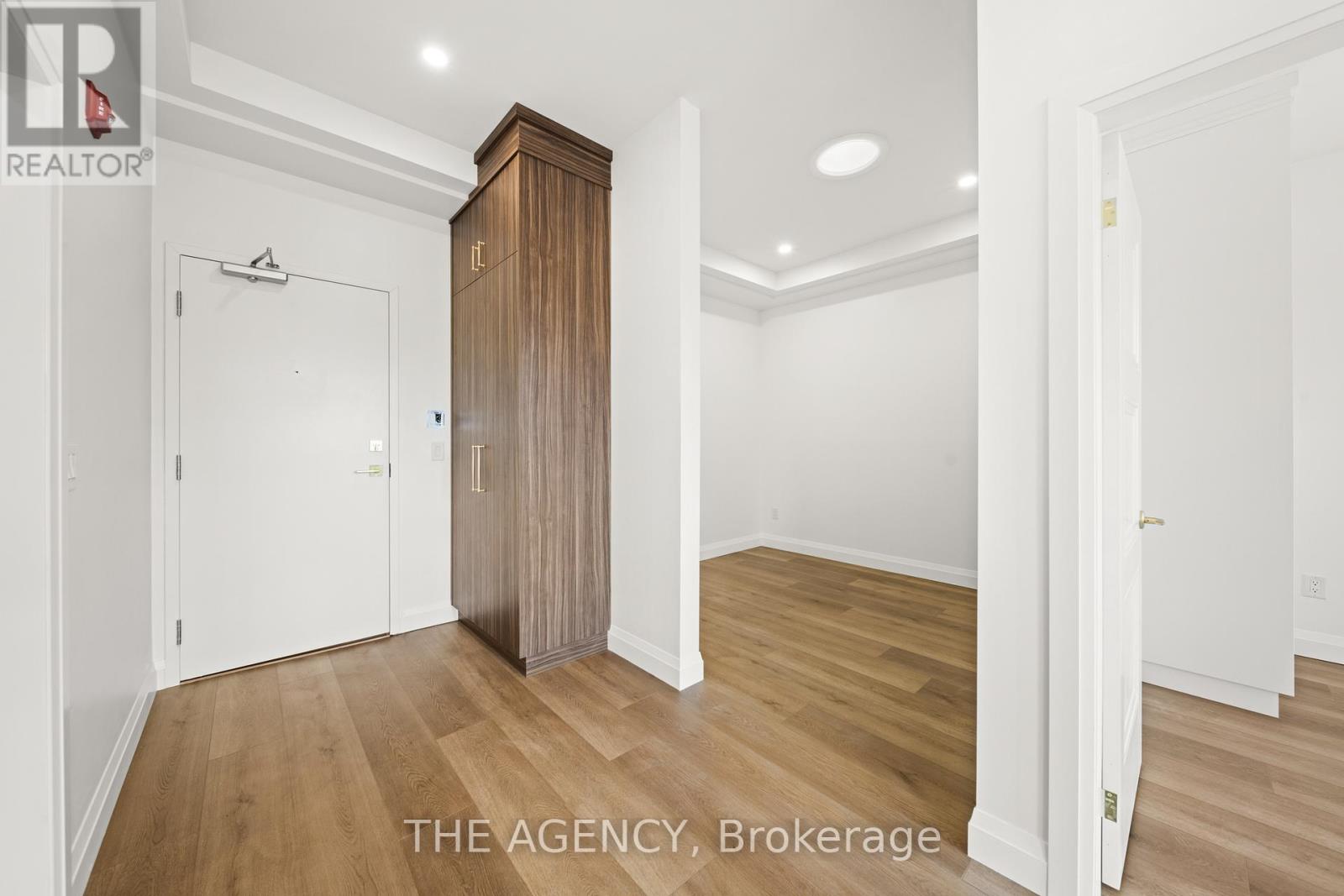 A room with a wooden floor and a white door.