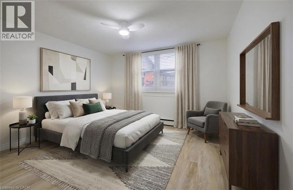 A bedroom with a large bed, a chair, and a painting on the wall.