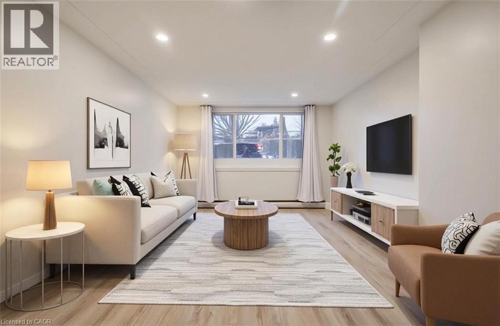 A well-lit, modern living room with a white sofa, a coffee table, and a television.