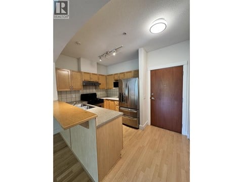 A kitchen with wooden cabinets and a counter top.