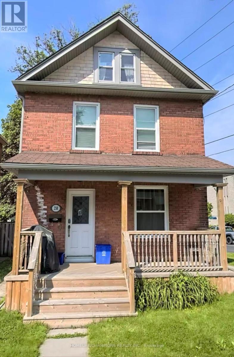 A small red brick house with a white door and a porch.