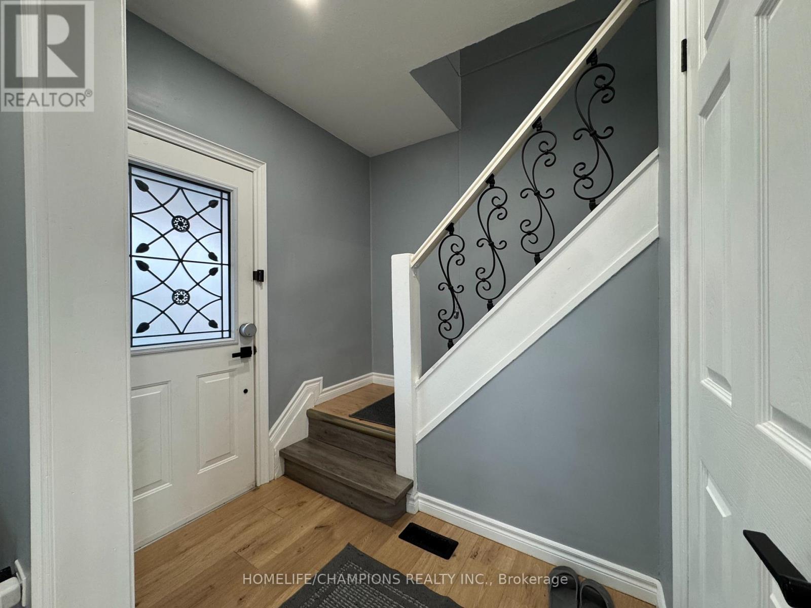 A staircase with a metal railing and wooden steps.