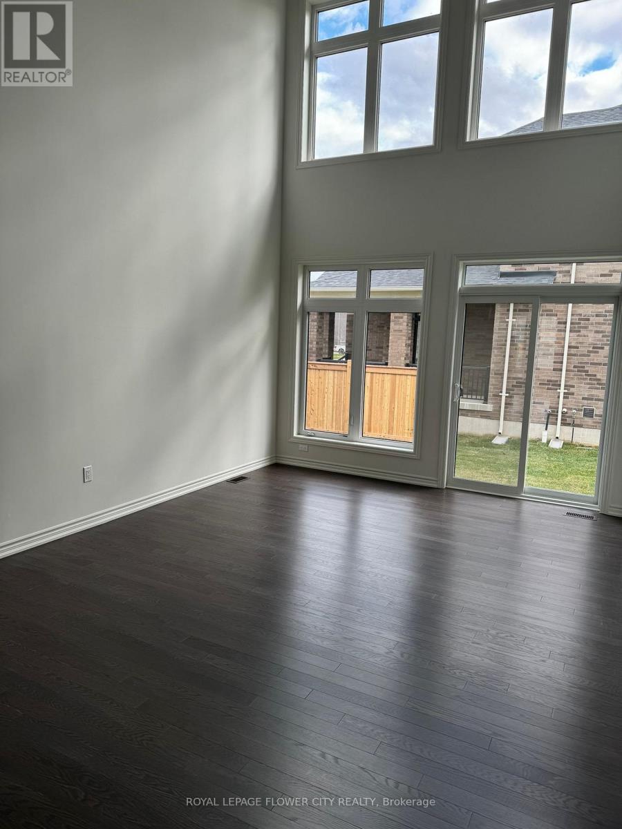 A room with a wooden floor and a large window.