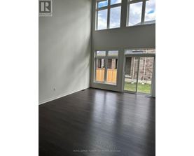 A room with a wooden floor and a large window.