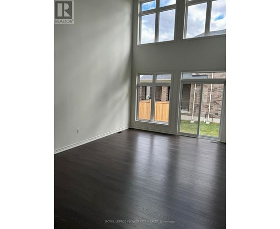 A room with a wooden floor and a large window.
