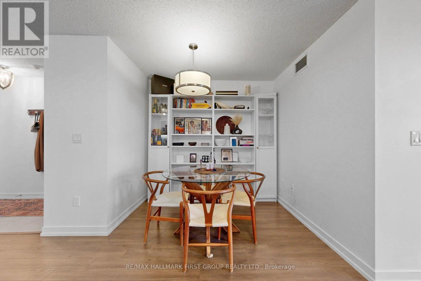 A dining room with a table and chairs.