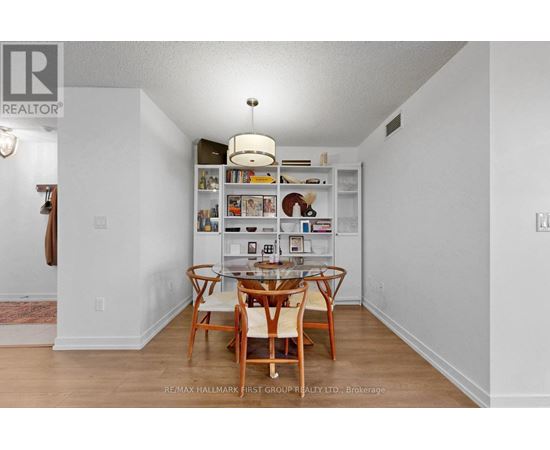 A dining room with a table and chairs.