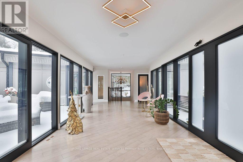 A spacious room with a Christmas tree and a basket of flowers on the floor.