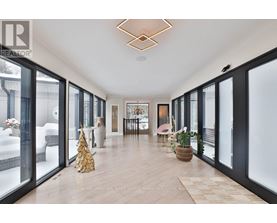 A spacious room with a Christmas tree and a basket of flowers on the floor.