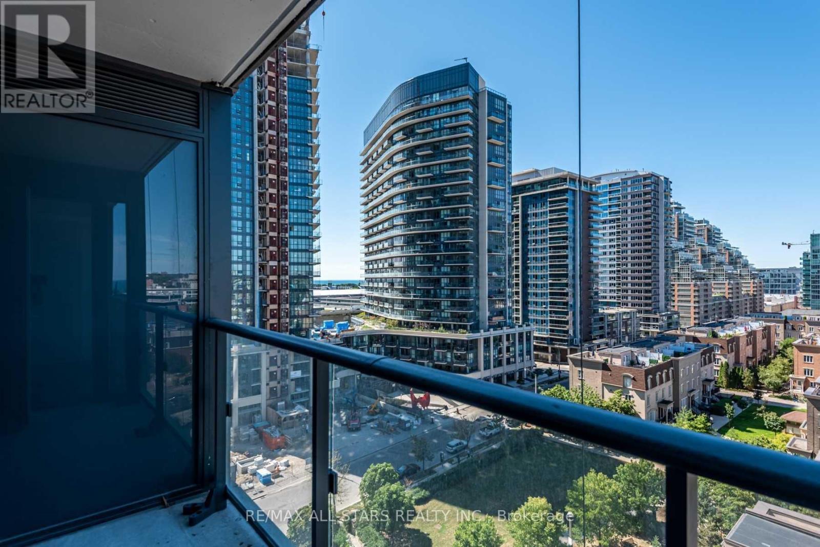 A balcony overlooks a cityscape with modern buildings.