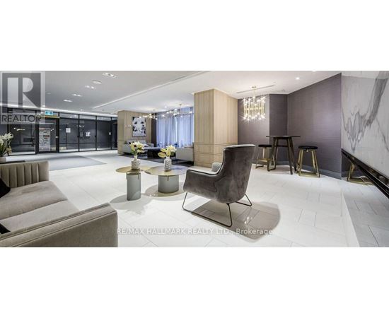 A modern living room with a grey sofa and a black chair.