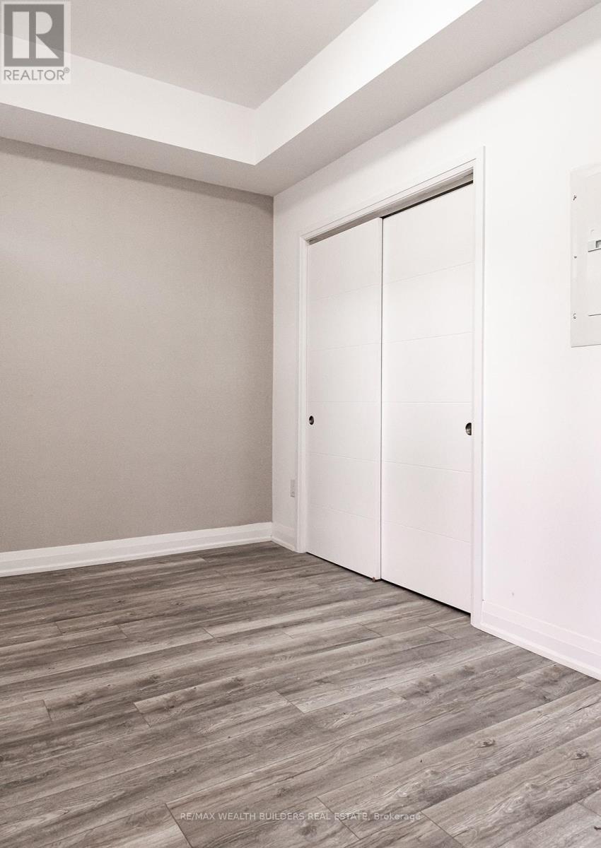 A room with a sliding door and wood flooring.