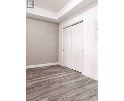 A room with a sliding door and wood flooring.