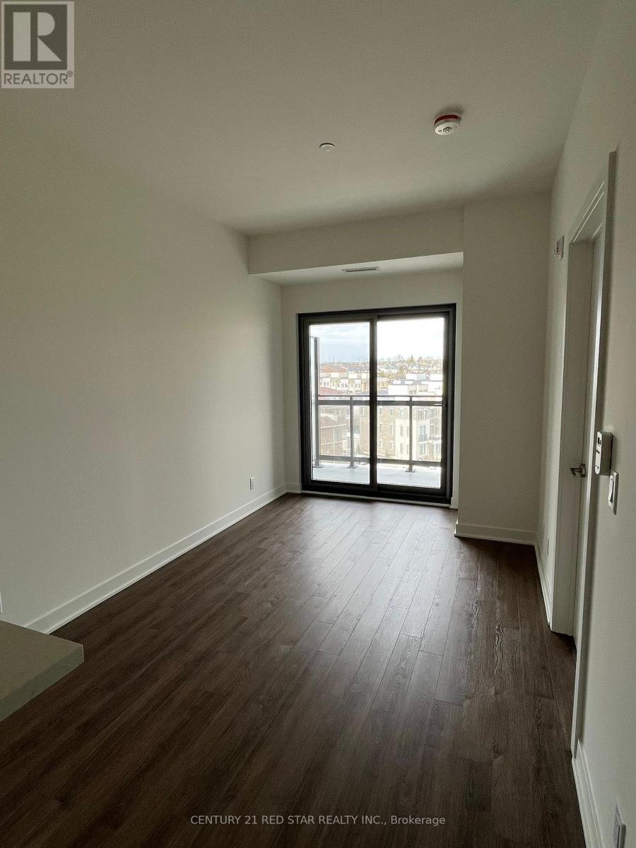 A room with wooden floors and a large window.