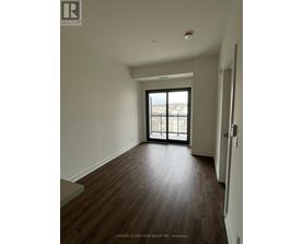 A room with wooden floors and a large window.