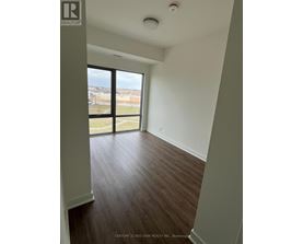 A room with a view of the outside through a large window.
