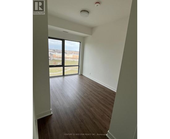 A room with a view of the outside through a large window.